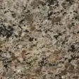 Light brown granite color swatch with dark clusters